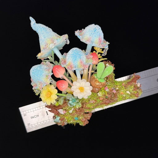 Handmade blue glitter mushroom cluster resin clay magnet with flowers and berries on log base, overhead view with ruler approx 1 inch – Sylva Garden