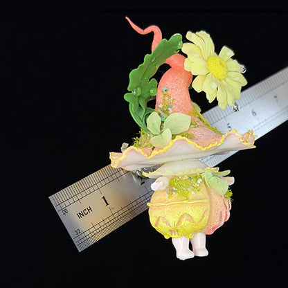 Handmade daisy wisp fairy mushroom resin clay magnet showing cap top with yellow daisy oak leaf and pink tendril details, overhead view with ruler – Sylva Garden