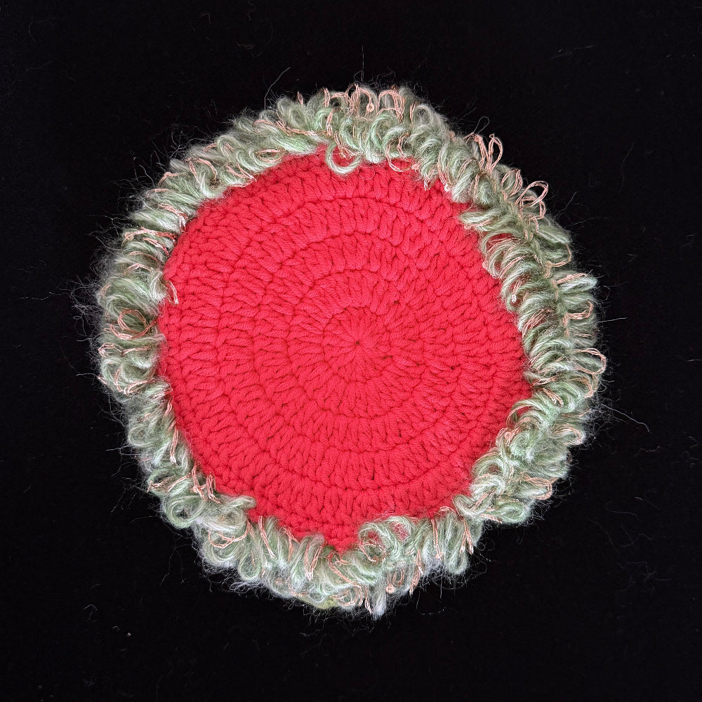 Handmade Dewbell lily of the valley crochet moss coaster back view showing red crochet base with light green moss border on black background – Sylva Garden