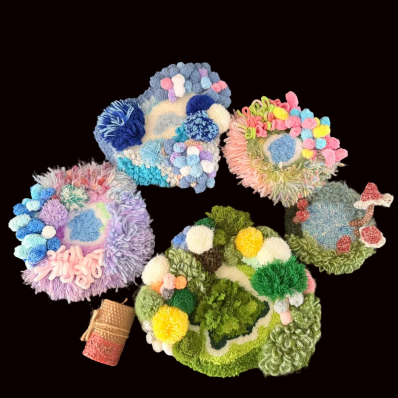 Handmade crochet moss coaster collection group shot showing Dreamy Bog lavender coral, Blossom Puddle pink pastel, Tidal Moss blue white, and green moss varieties on black background – Sylva Garden