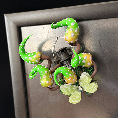 Handmade eldritch tentacle lantern resin clay magnet with green spotted tentacles attached to metal refrigerator door, lifestyle view – Sylva Garden