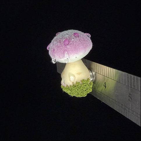 Handmade fluffy russula resin clay fridge magnet in purple with moss base, side view with size reference ruler on black background – Sylva Garden