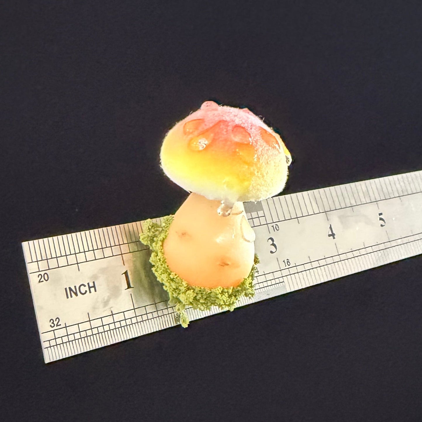 Handmade fluffy russula resin clay fridge magnet in orange yellow with moss base and size reference ruler on black background – Sylva Garden