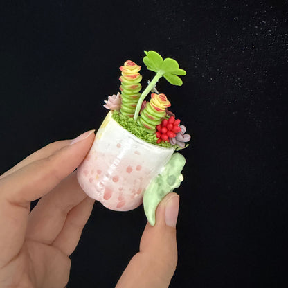 Little Croc Garden clay succulent held in hand — back view of crocodile pot