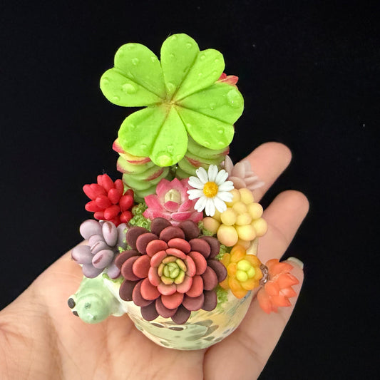 Little Croc Garden clay succulent held in hand — top view of hand-sculpted blooms