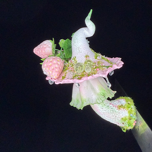 Handmade milky spore strawberry mushroom resin clay magnet showing cap top with strawberry rose and crystal bead details, angled view with ruler on black background – Sylva Garden