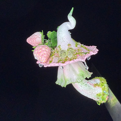 Handmade milky spore strawberry mushroom resin clay magnet showing cap top with strawberry rose and crystal bead details, angled view with ruler on black background – Sylva Garden