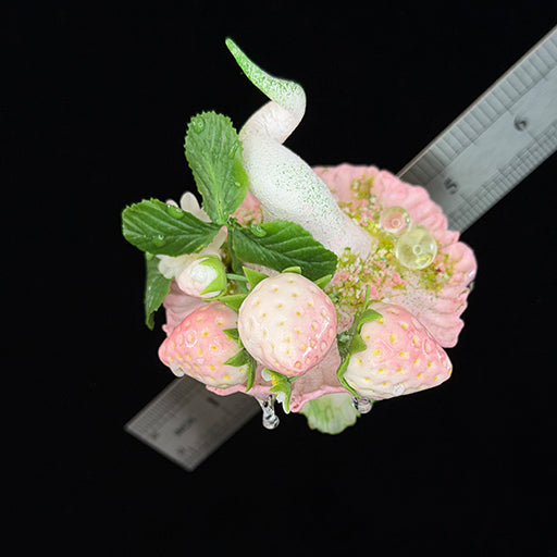 Handmade milky spore strawberry mushroom resin clay magnet showing cap top with strawberry rose mint leaf and crystal bead arrangement, overhead view with ruler – Sylva Garden