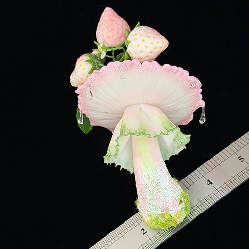 Handmade milky spore strawberry mushroom resin clay magnet full front view showing ruffled stem and strawberry crown with ruler for scale on black background – Sylva Garden