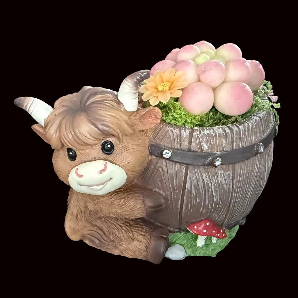 Handmade highland cow resin planter right side view showing brown cow face with wooden barrel pink Peach Girl succulent orange flower moss and red mushroom accent – Sylva Garden