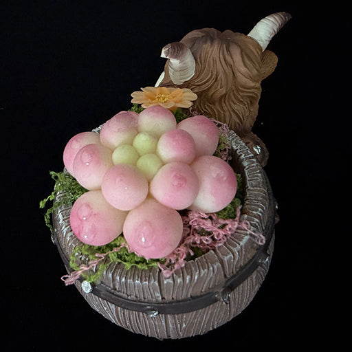 Handmade highland cow resin planter top view showing pink clay succulent cluster orange flower and green moss arrangement inside wooden barrel – Sylva Garden