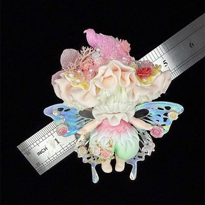 Handmade petal wing butterfly resin clay fridge magnet full front view with holographic wings ruffled cap and rose crown, size reference ruler approx 4 inches on black background – Sylva Garden