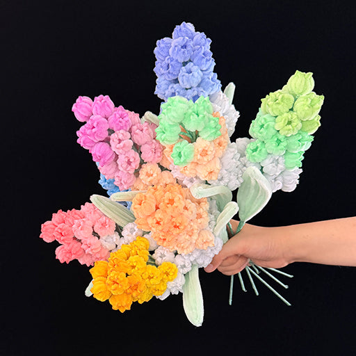 Handmade pipe cleaner grape hyacinth — 8 pastel shades bouquet held in hand, front view
