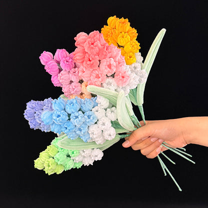 Handmade pipe cleaner grape hyacinth — 8 pastel shades bouquet held in hand, side view
