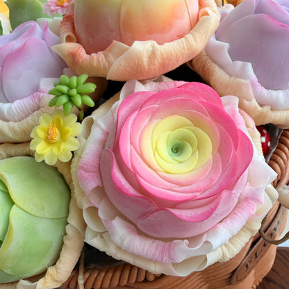 Rose Succulent Carnival handmade clay close-up showing pink gradient ranunculus center with yellow daisy and green succulent rosette detail in woven basket – Sylva Garden