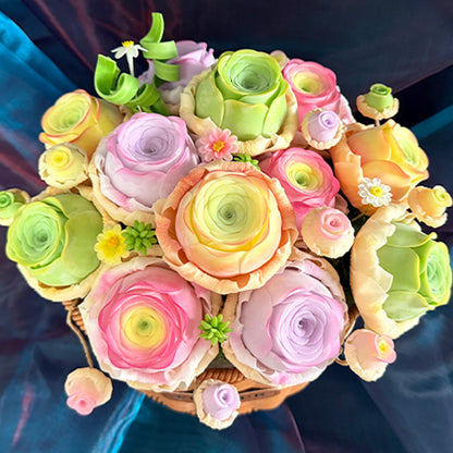 Rose Succulent Carnival handmade clay ranunculus and rose-shaped succulent arrangement overhead view showing full pastel pink orange purple green bouquet in woven basket – Sylva Garden