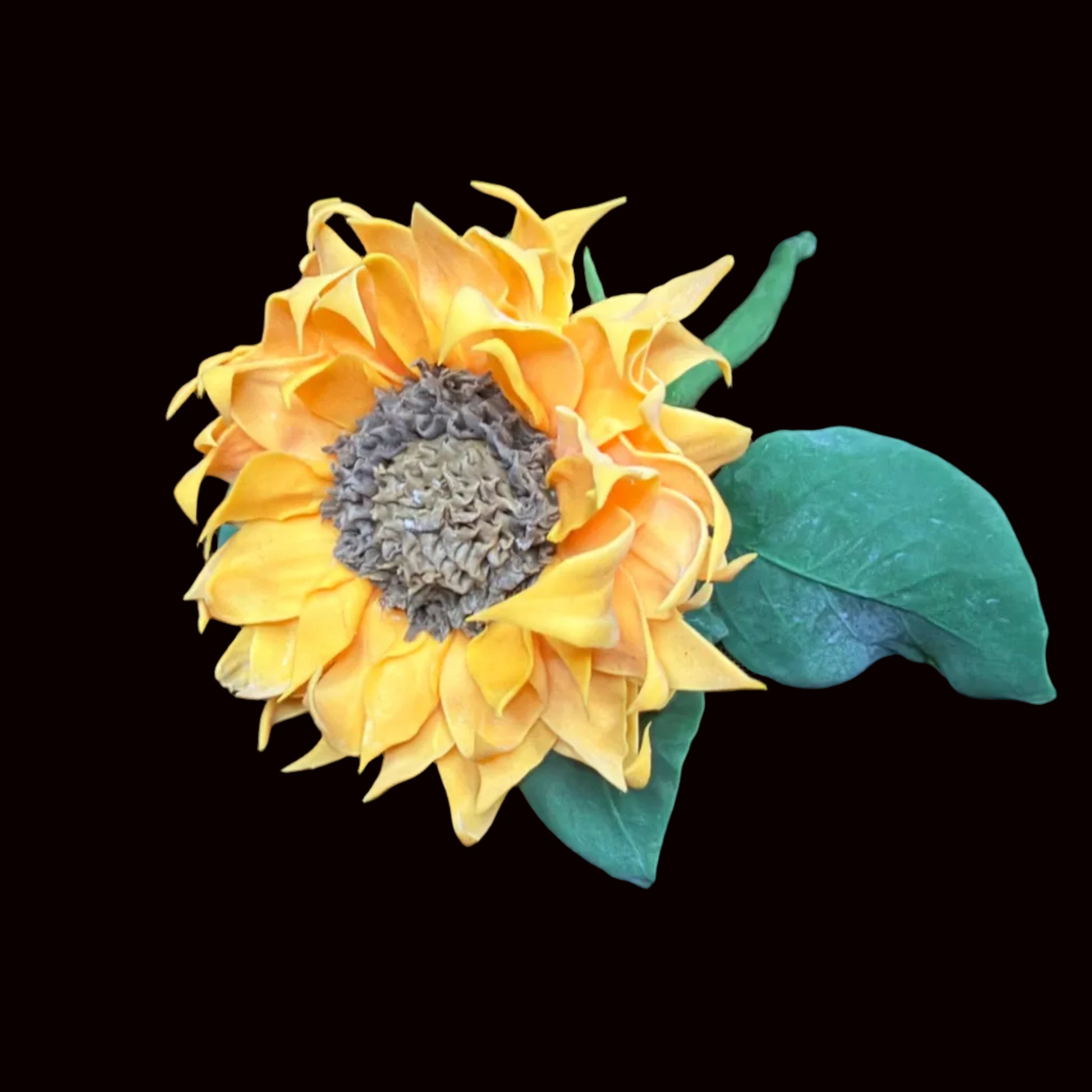 Handmade resin clay yellow sunflower close-up showing hand-sculpted layered petals and textured seed center with green leaves – Sylva Garden