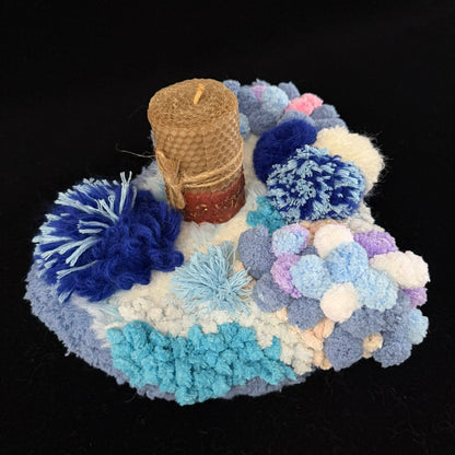 Handmade Tidal Moss blue white gradient pom-pom crochet coaster with beeswax pillar candle on black background, overhead lifestyle view – Sylva Garden