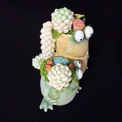 Handmade frog resin succulent planter duo side view showing tan frog with white succulent wing clusters and green frog with clay flower detail – Sylva Garden
